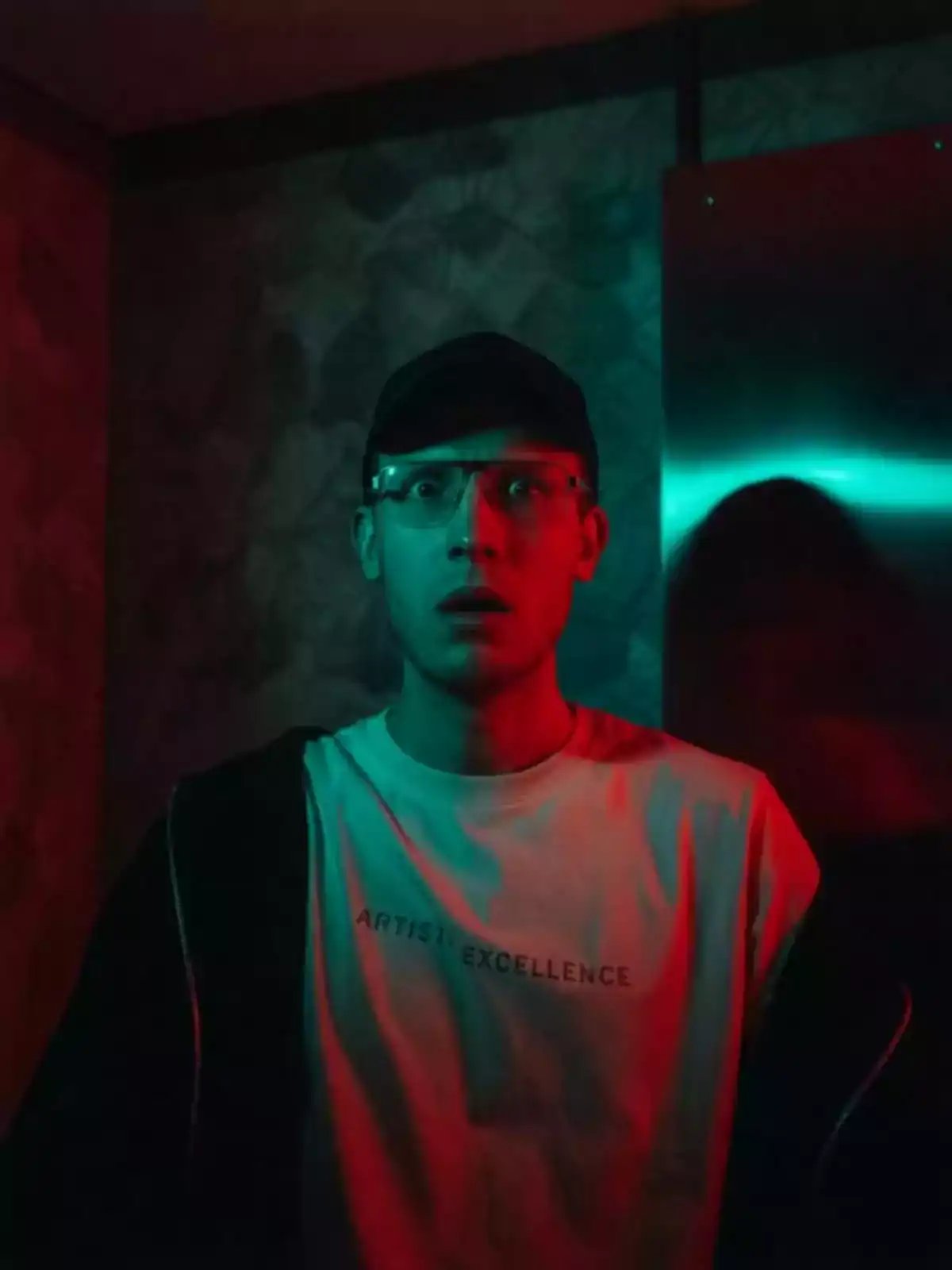 A cinematic scene features a person initially in casual attire and glasses confronting a figure dressed in a skeleton costume and hood, with eerie lighting and a knife in the skeleton figure's hand, showcasing a dramatic style suitable for an AI video maker focused on cinematic AI video and photorealistic AI art.